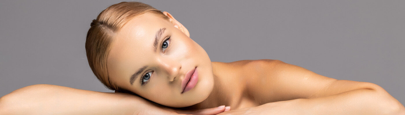 Beauty category background image depicting a woman with her head leaning on her arm.