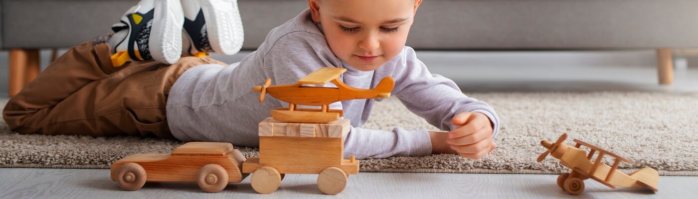 Children's category background image depicting a child playing with wooden toys.
